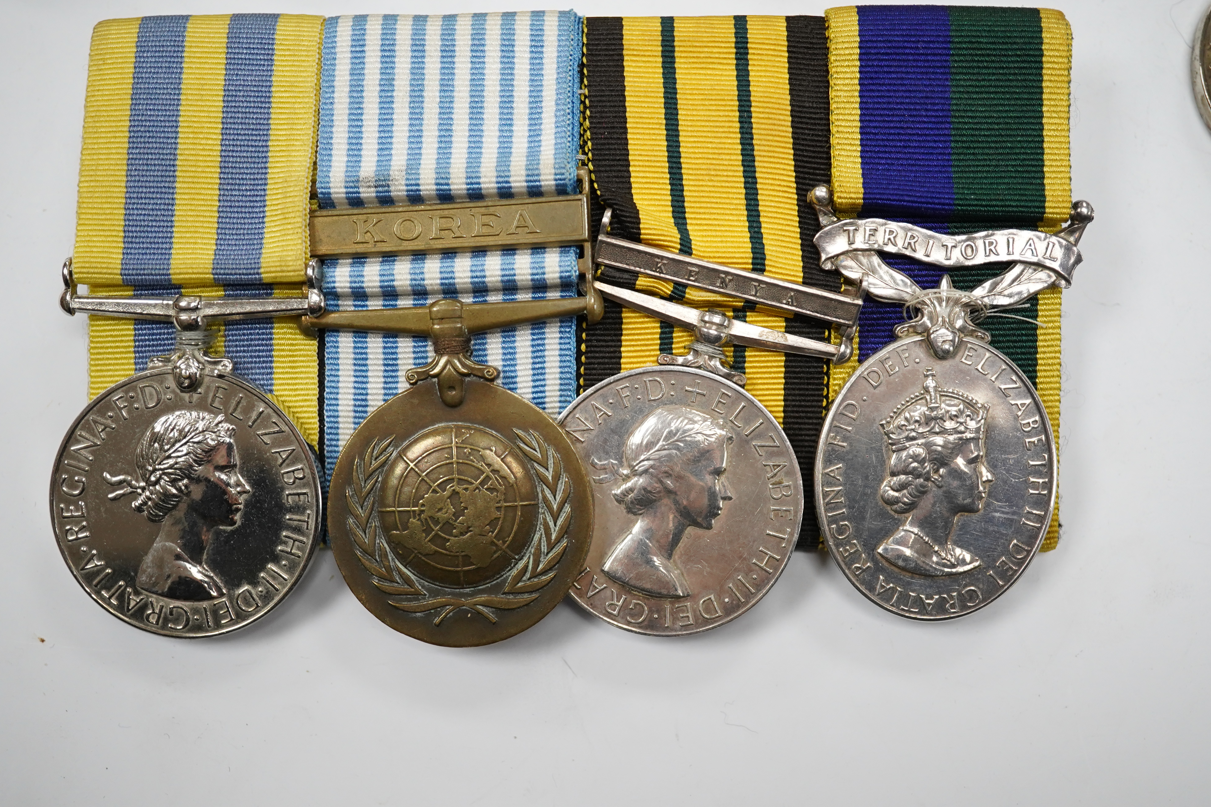 Twelve ERII and George VI medals, some medals arranged into two medals groups (containing unnamed medals and medals awarded to different recipients within the same group), including